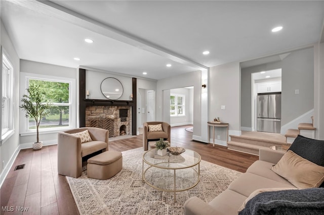 17617 Lomond Blvd, Shaker Heights, OH 44120 - living room featuring baseboards, wood finished floors, recessed lighting, a stone fireplace, and stairs