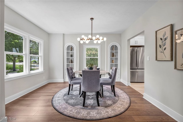 17617 Lomond Blvd, Shaker Heights, OH 44120 - dining area with a chandelier, wood finished floors, and baseboards