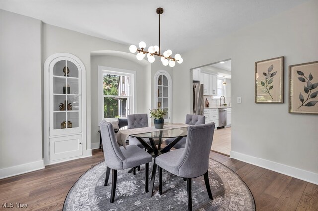 17617 Lomond Blvd, Shaker Heights, OH 44120 - dining area with a chandelier, dark wood finished floors, and baseboards