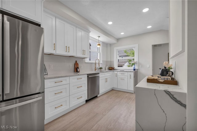 17617 Lomond Blvd, Shaker Heights, OH 44120 - kitchen featuring appliances with stainless steel finishes, a sink, recessed lighting, white cabinets, and light wood-type flooring