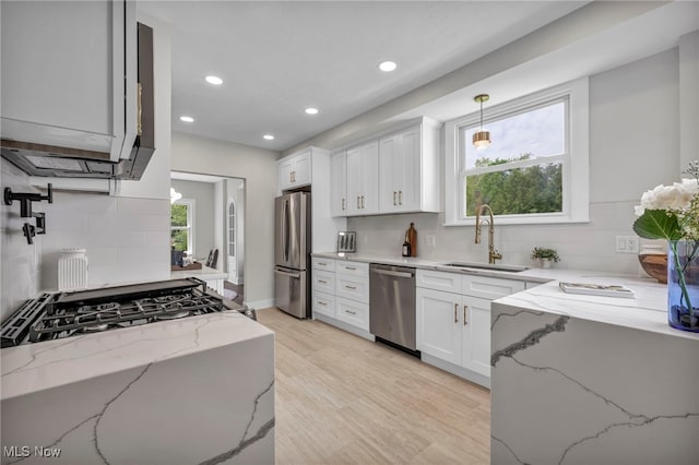 17617 Lomond Blvd, Shaker Heights, OH 44120 - kitchen with stainless steel appliances, a sink, decorative backsplash, recessed lighting, and light stone countertops