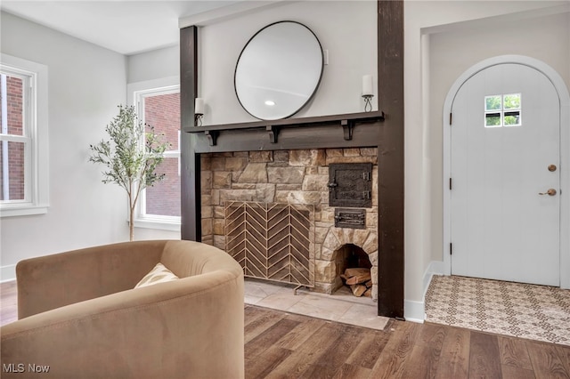17617 Lomond Blvd, Shaker Heights, OH 44120 - living area featuring a stone fireplace, wood finished floors, and baseboards