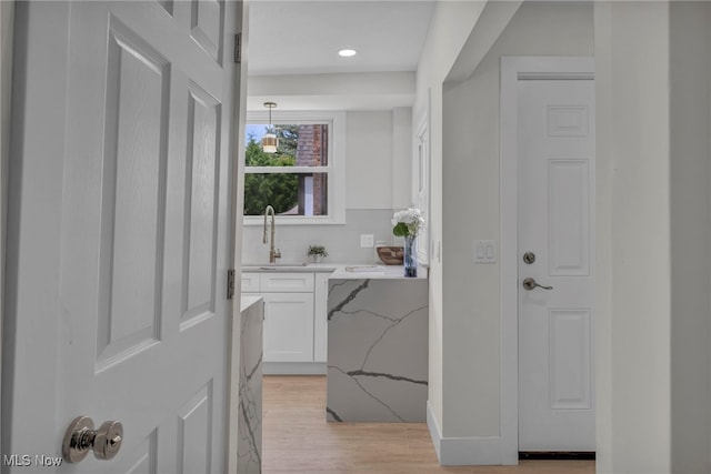17617 Lomond Blvd, Shaker Heights, OH 44120 - hallway with a sink, light wood finished floors, and recessed lighting