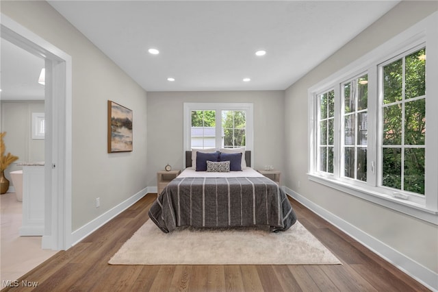 17617 Lomond Blvd, Shaker Heights, OH 44120 - bedroom with baseboards, wood finished floors, recessed lighting, and ensuite bath
