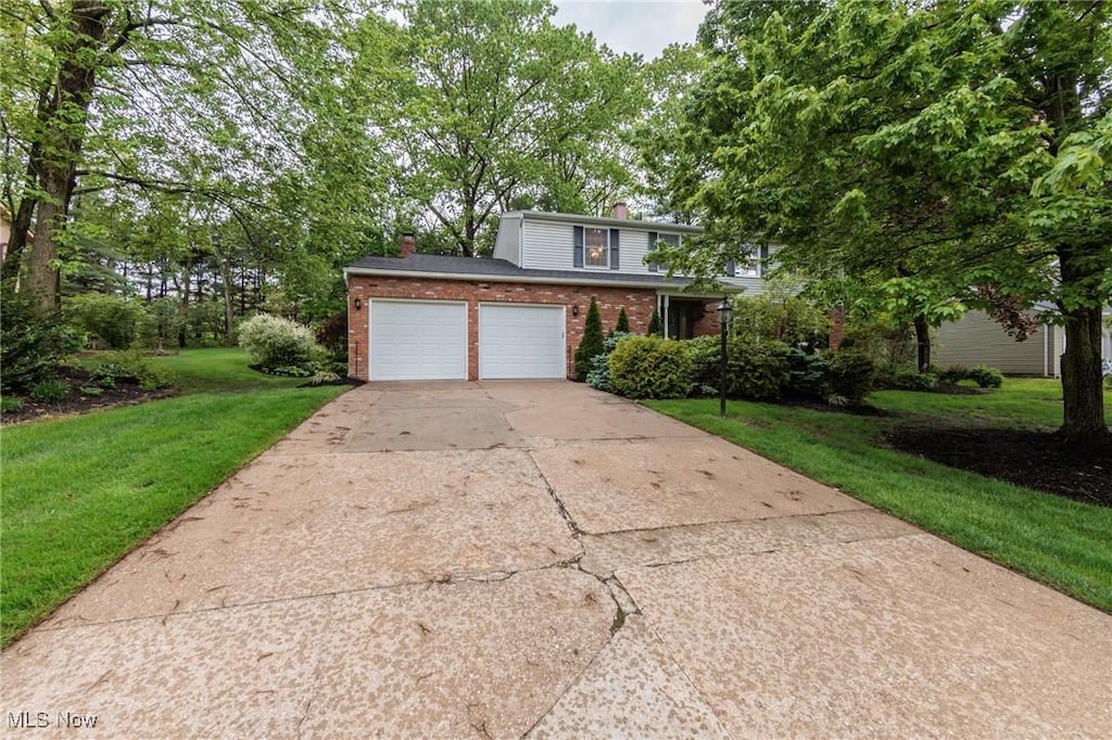 10222 Deer Run, Brecksville, OH 44141 - traditional-style home featuring brick siding, a chimney, concrete driveway, a front lawn, and a garage