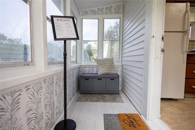 sunroom featuring wallpapered walls