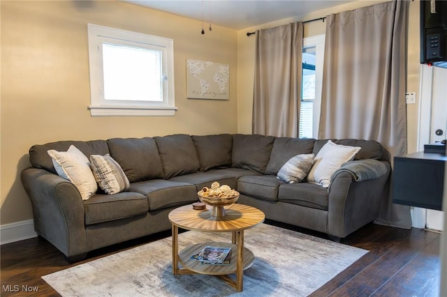 living area featuring dark wood finished floors and baseboards