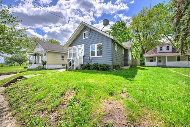 1254 Delos St, Akron, OH 44306 - back of property with a lawn and covered porch