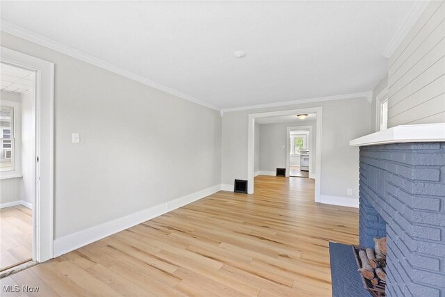 1254 Delos St, Akron, OH 44306 - unfurnished living room with a fireplace, light wood-type flooring, crown molding, and baseboards