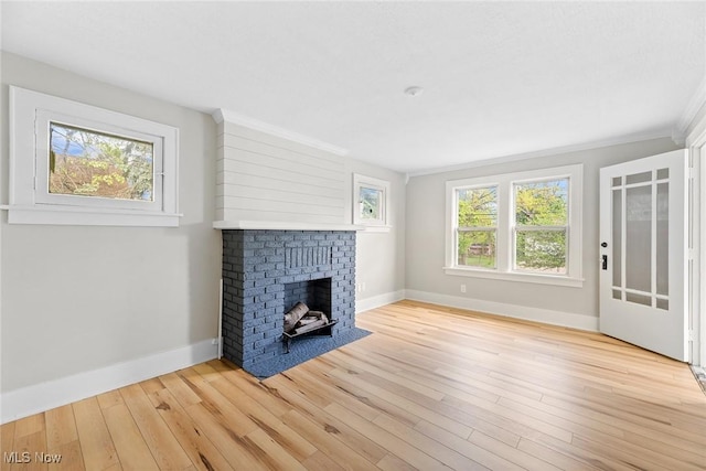 1254 Delos St, Akron, OH 44306 - unfurnished living room with baseboards, healthy amount of natural light, light wood-type flooring, a fireplace, and ornamental molding