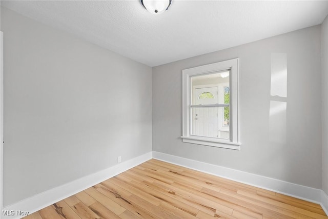 1254 Delos St, Akron, OH 44306 - unfurnished room with wood finished floors and baseboards