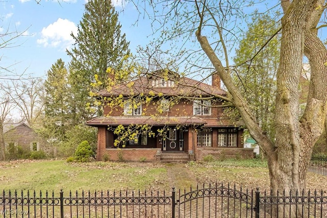 245 Merriman Rd, Akron, OH 44303 - view of front facade featuring a chimney, brick siding, and a gate