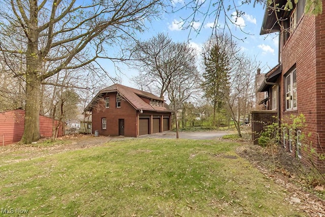 245 Merriman Rd, Akron, OH 44303 - view of green lawn featuring an attached garage and driveway