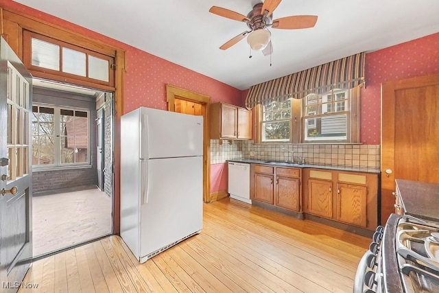 245 Merriman Rd, Akron, OH 44303 - kitchen with white appliances, wallpapered walls, light wood finished floors, a sink, and ceiling fan