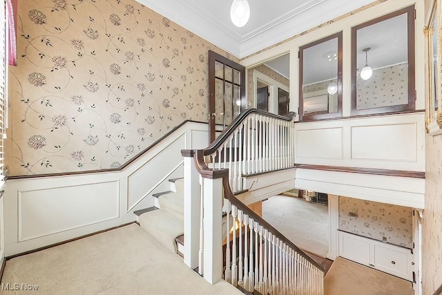 245 Merriman Rd, Akron, OH 44303 - stairway featuring wallpapered walls, a decorative wall, wainscoting, carpet, and crown molding