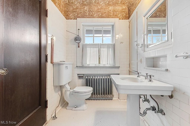 245 Merriman Rd, Akron, OH 44303 - bathroom with radiator, tile walls, and toilet