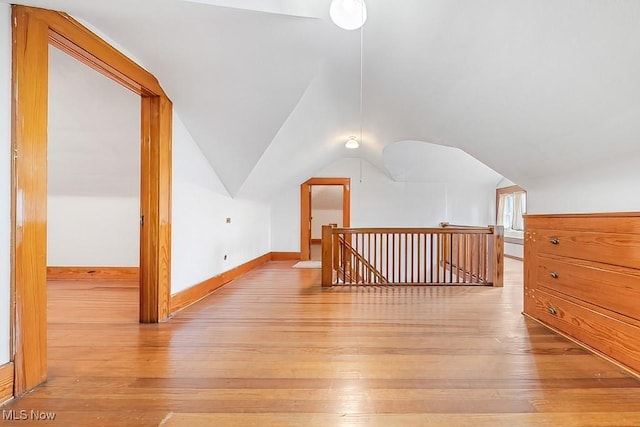 245 Merriman Rd, Akron, OH 44303 - additional living space with light wood-style floors, lofted ceiling, and baseboards