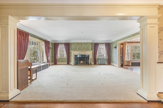 245 Merriman Rd, Akron, OH 44303 - unfurnished living room featuring crown molding, decorative columns, a lit fireplace, carpet flooring, and wallpapered walls