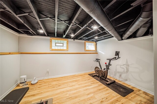 exercise room featuring wood finished floors and baseboards
