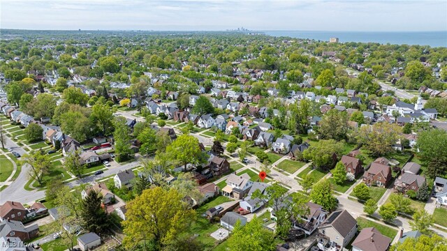view of property location with nearby suburban area and a large body of water
