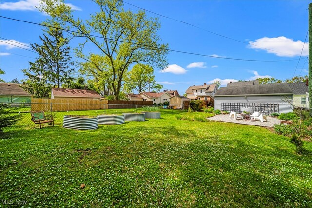 view of yard with a vegetable garden and a patio