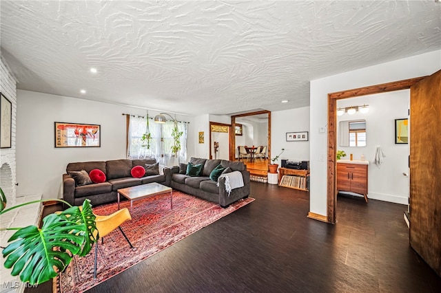 living area featuring dark wood-type flooring, plenty of natural light, and recessed lighting