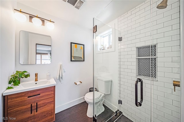 bathroom with a shower stall, toilet, and healthy amount of natural light