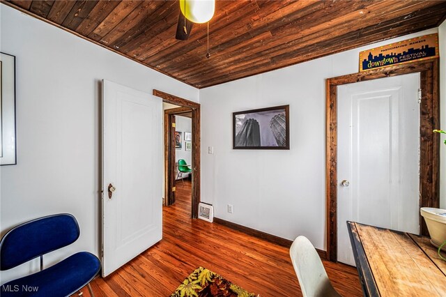office with wooden ceiling, dark wood-style flooring, and baseboards