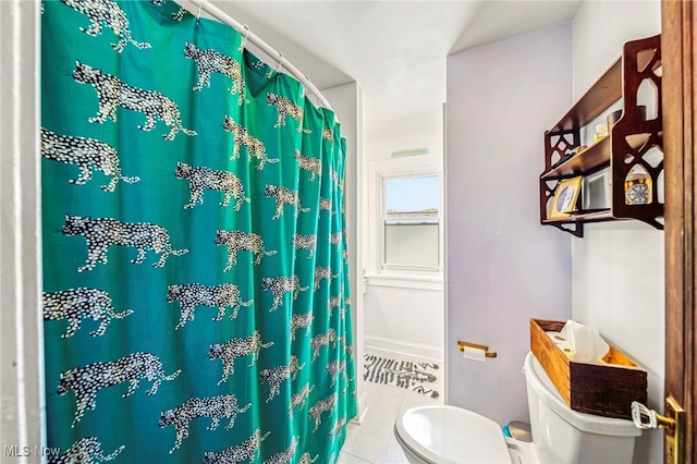 bathroom with toilet, tile patterned floors, and curtained shower