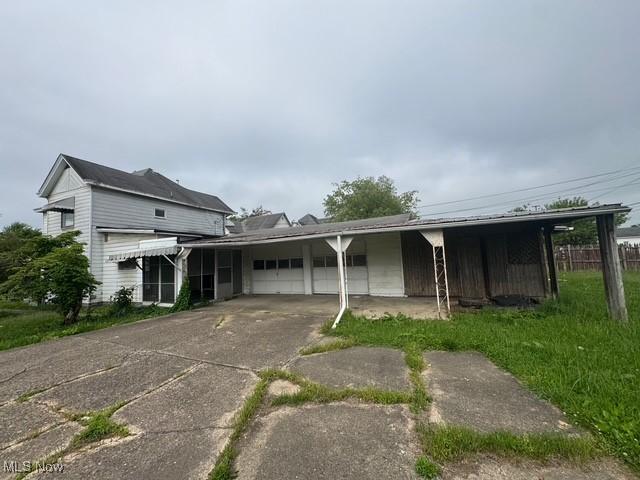 234 High Ave, Byesville, OH 43723 - view of front facade featuring an attached garage and driveway