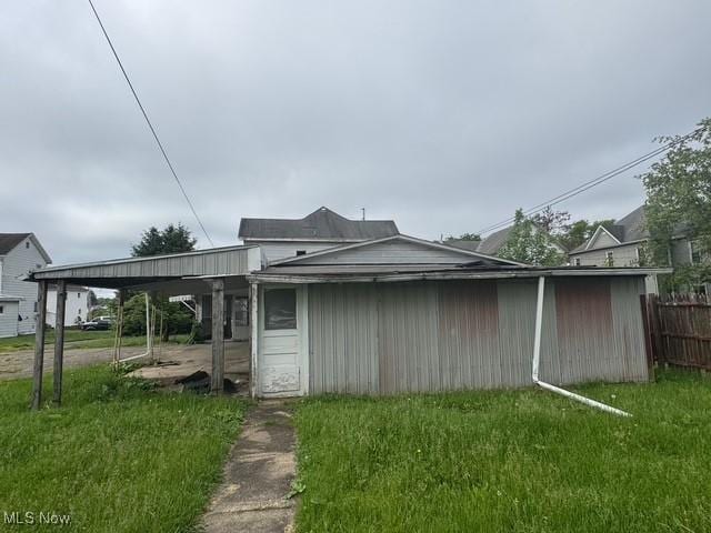 234 High Ave, Byesville, OH 43723 - view of side of home with fence and an attached carport