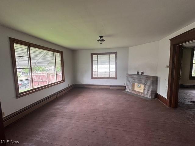 234 High Ave, Byesville, OH 43723 - unfurnished living room featuring wood-type flooring, baseboards, a fireplace, and baseboard heating