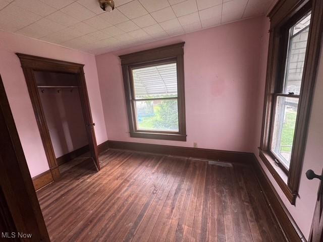 234 High Ave, Byesville, OH 43723 - unfurnished bedroom featuring hardwood / wood-style floors and baseboards