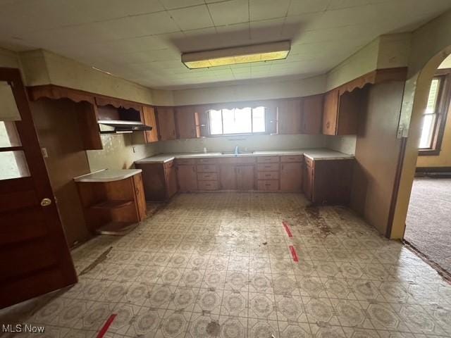 234 High Ave, Byesville, OH 43723 - kitchen with light flooring, brown cabinets, arched walkways, open shelves, and light countertops