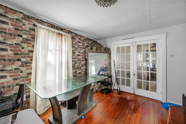 132 Irondale St, Elyria, OH 44035 - dining area featuring brick wall, hardwood / wood-style flooring, a textured ceiling, french doors, and crown molding