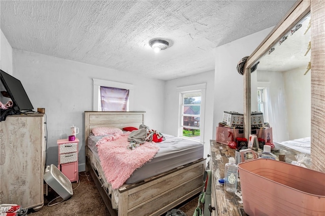 132 Irondale St, Elyria, OH 44035 - bedroom featuring a textured ceiling and dark carpet