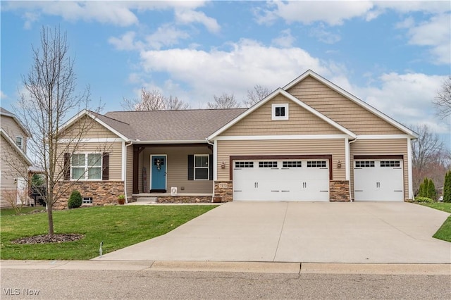 7273 Ashmoore Ave NW, North Canton, OH 44720 - craftsman inspired home featuring a garage, a front yard, driveway, and stone siding