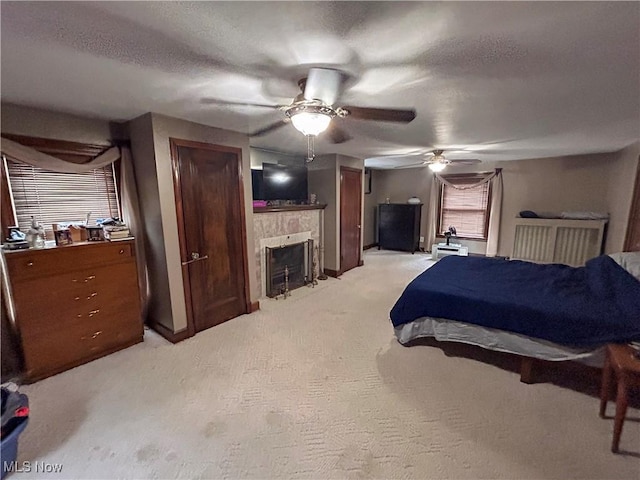 553 Willard Ave SE, Warren, OH 44483 - bedroom with a fireplace with flush hearth, light colored carpet, and a ceiling fan