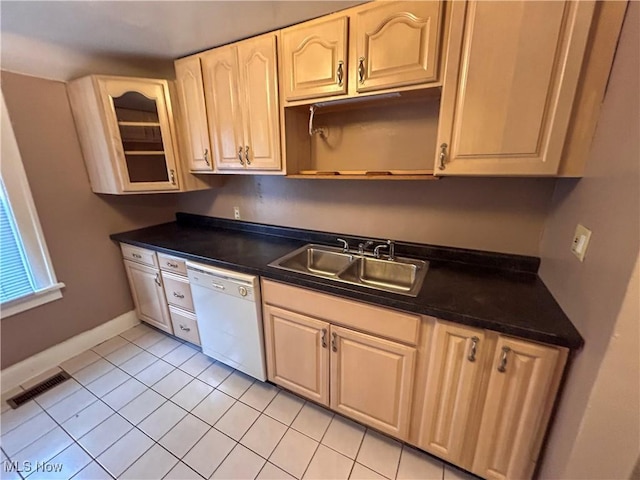 553 Willard Ave SE, Warren, OH 44483 - kitchen featuring dishwasher, light tile patterned floors, dark countertops, and glass insert cabinets