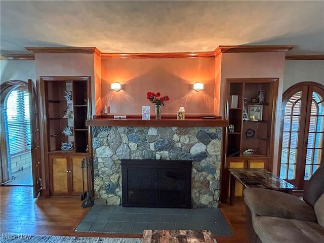 553 Willard Ave SE, Warren, OH 44483 - living room with crown molding, a stone fireplace, and wood finished floors