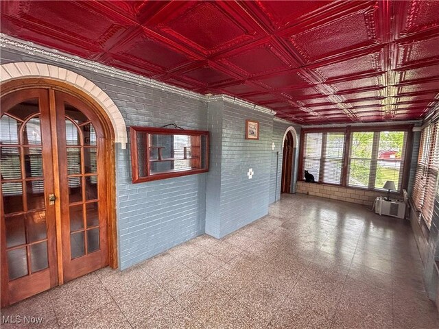 553 Willard Ave SE, Warren, OH 44483 - unfurnished sunroom featuring french doors and arched walkways