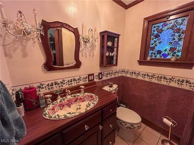 553 Willard Ave SE, Warren, OH 44483 - half bath with tile patterned flooring, vanity, wainscoting, tile walls, and ornamental molding