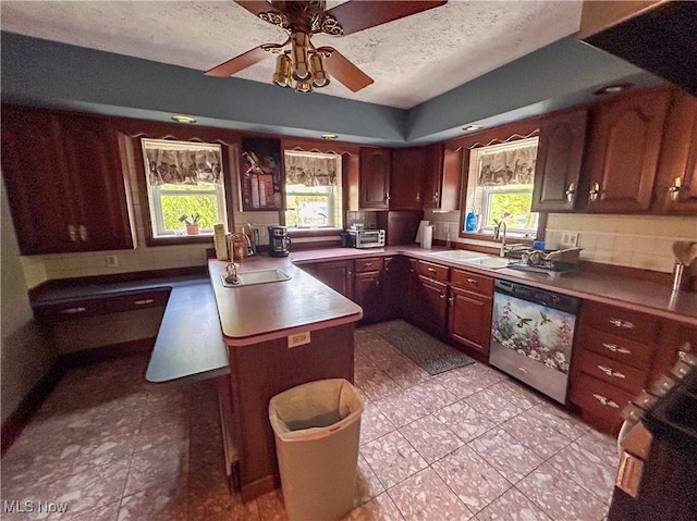 553 Willard Ave SE, Warren, OH 44483 - kitchen featuring dishwashing machine, a peninsula, healthy amount of natural light, range, and a textured ceiling