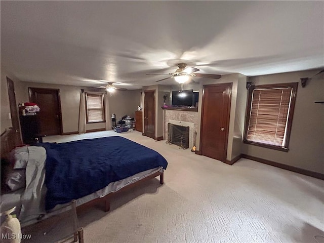 553 Willard Ave SE, Warren, OH 44483 - bedroom with a fireplace, light colored carpet, and a ceiling fan
