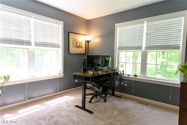 carpeted home office featuring baseboards
