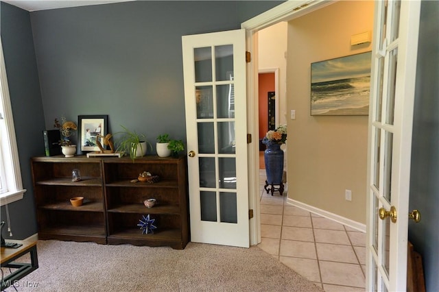 bedroom with french doors, light tile patterned floors, and baseboards