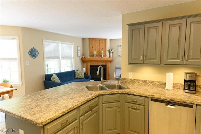 kitchen with dishwasher, a sink, a peninsula, and open floor plan