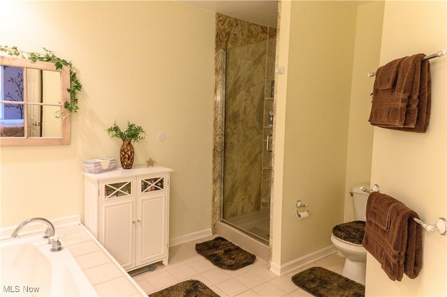 full bath with a stall shower, toilet, tile patterned flooring, a bath, and baseboards