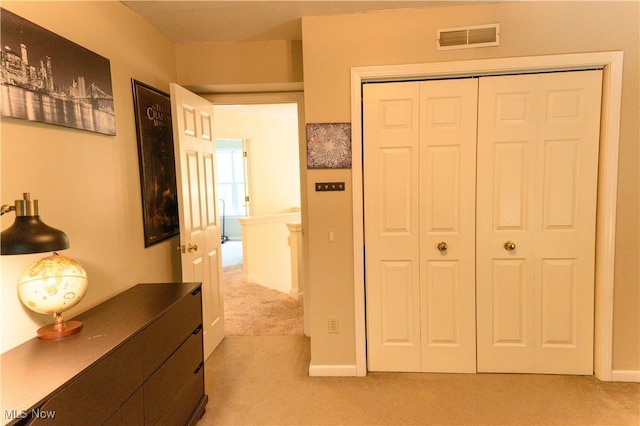 bedroom featuring light carpet and a closet