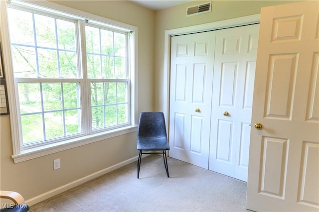 living area featuring carpet flooring and baseboards